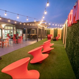 a courtyard with string lights and outdoor seating