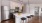 a kitchen with a white counter top and a white refrigerator