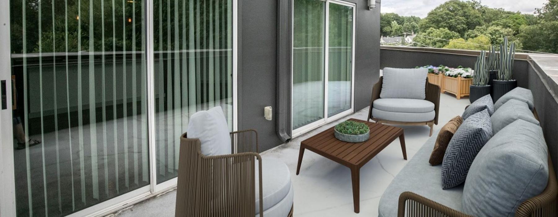a spacious balcony with lounge seating